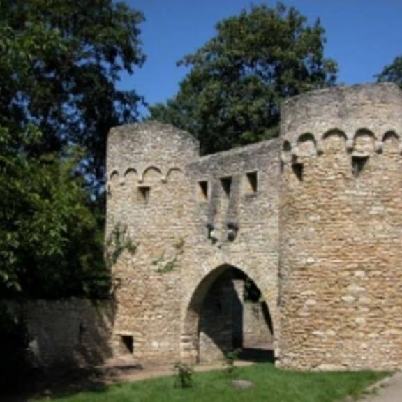 © Copyright/Quelle: www.ingelheim.de • Die Wehrmauer in Ober-Ingelheim wurde vermutlich im frühen 15. Jahrhundert errichtet. Sie besitzt einen Zinnenkranz und ist bis zu 8 m hoch und bis zu 2 m dick. Über eine längere Strecke war der Mauer ein Graben mit Bachlauf vorgelagert. Das von der Wehrmauer eingeschlossene Gelände hätte den Einwohnern im Falle eines Angriffs zum Rückzug dienen sollen, was aber nie nötig war. In die Mauer waren mehrere Türme eingefügt, die zum Teil noch erhalten und an ihren charakteristischen Steinkegeldächern zu erkennen sind. Ebenfalls noch erhalten sind das „Uffhubtor“ und das Ohrenbrücker Tor. • © Copyright/Quelle: www.ingelheim.de